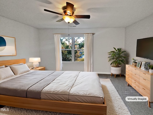 bedroom featuring dark colored carpet and ceiling fan