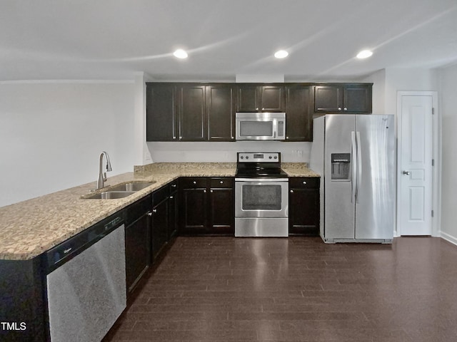 kitchen with kitchen peninsula, dark hardwood / wood-style flooring, stainless steel appliances, and sink