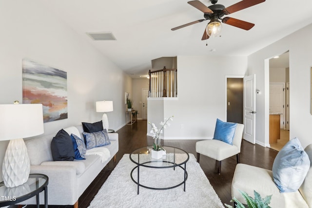 living room with dark wood-type flooring and ceiling fan