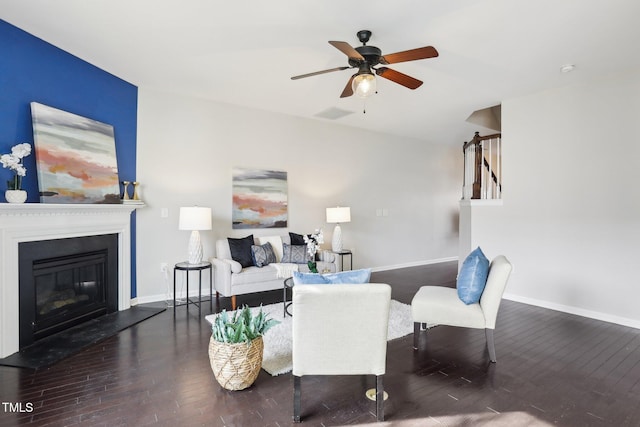 living room with dark wood-type flooring and ceiling fan