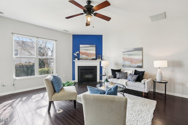 living room featuring dark hardwood / wood-style flooring and ceiling fan