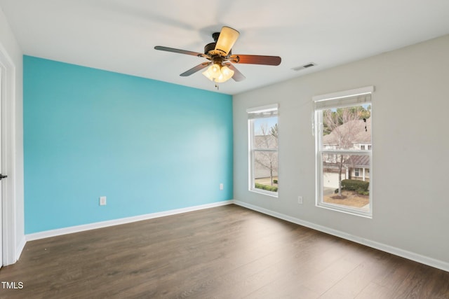 spare room featuring ceiling fan and dark hardwood / wood-style floors