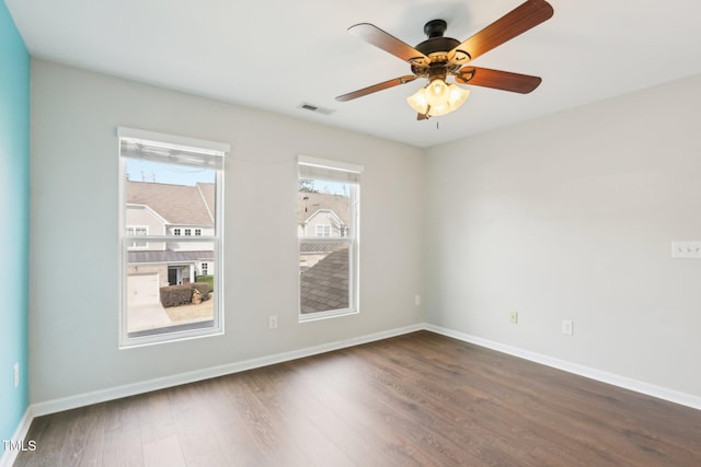 unfurnished room featuring ceiling fan and dark hardwood / wood-style flooring