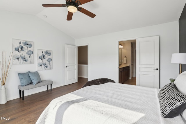 bedroom featuring vaulted ceiling, dark wood-type flooring, connected bathroom, and ceiling fan