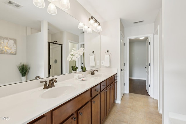 bathroom featuring vanity, tile patterned flooring, and walk in shower