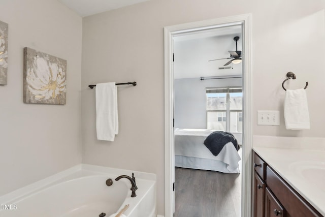 bathroom with ceiling fan, vanity, a bathing tub, and hardwood / wood-style floors