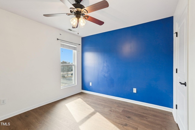 unfurnished room featuring hardwood / wood-style flooring and ceiling fan