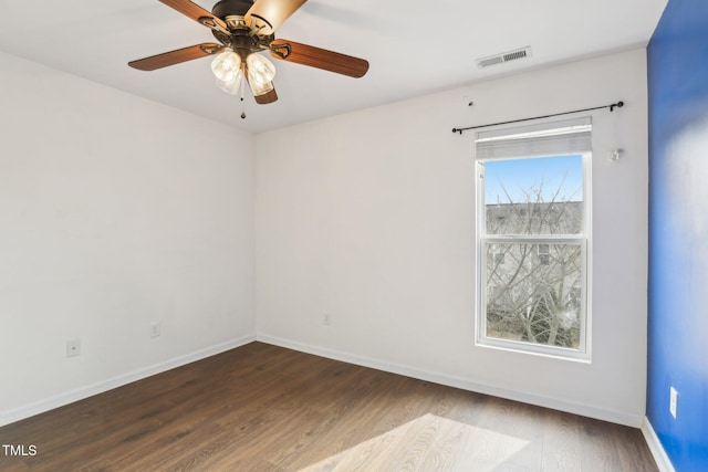 unfurnished room featuring dark hardwood / wood-style floors and ceiling fan