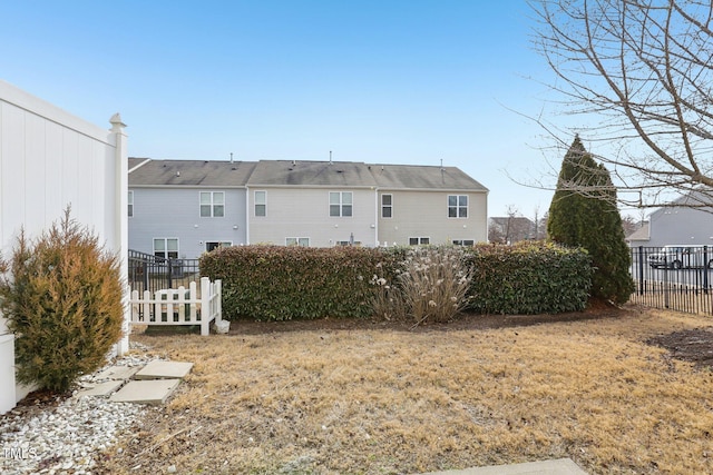 rear view of house with a yard