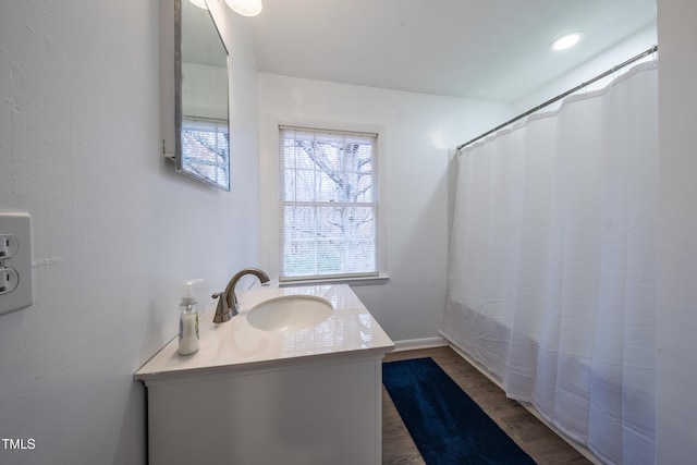 bathroom featuring hardwood / wood-style flooring, vanity, and curtained shower