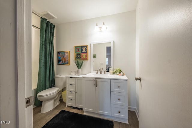 bathroom featuring hardwood / wood-style flooring, vanity, and toilet