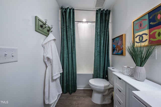 full bathroom featuring vanity, hardwood / wood-style flooring, toilet, and shower / bath combo with shower curtain