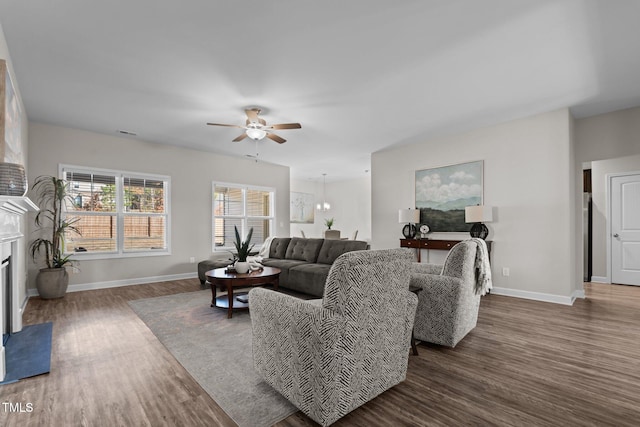 living room featuring ceiling fan and dark hardwood / wood-style flooring