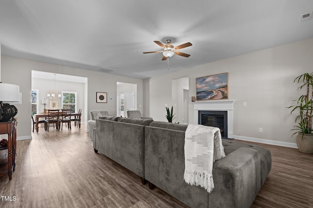 living room with dark hardwood / wood-style flooring and ceiling fan