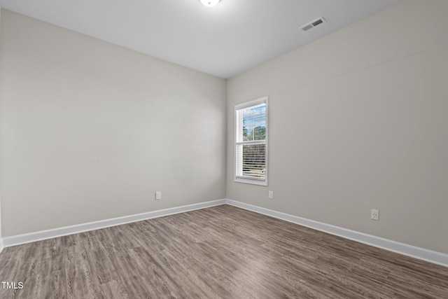 unfurnished room with hardwood / wood-style flooring