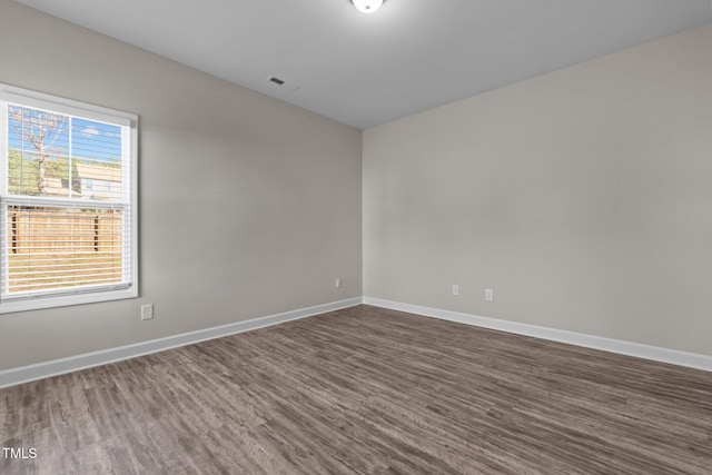 spare room with dark wood-type flooring