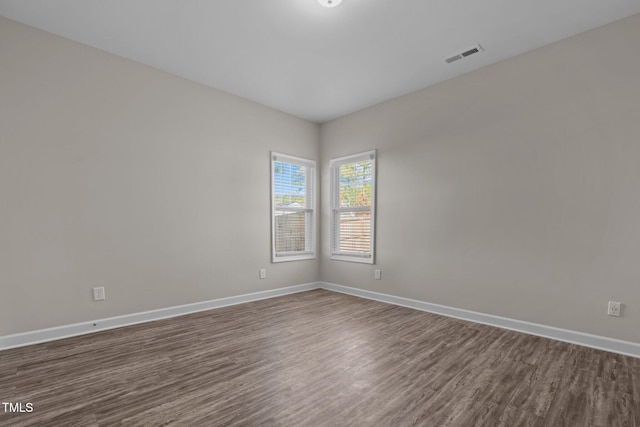 spare room featuring dark hardwood / wood-style floors