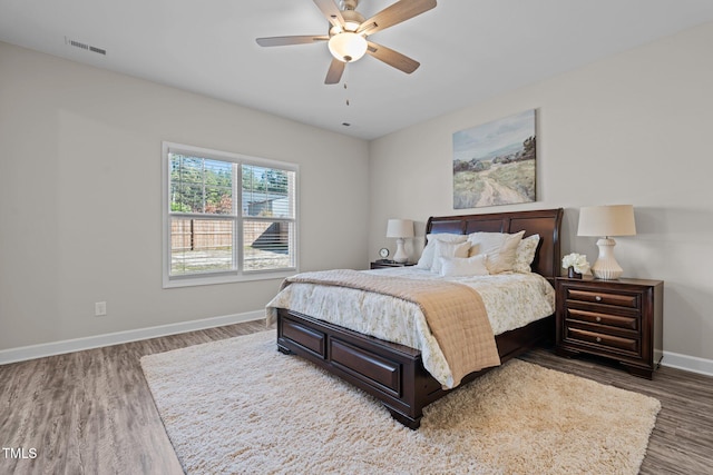 bedroom with ceiling fan and dark hardwood / wood-style floors