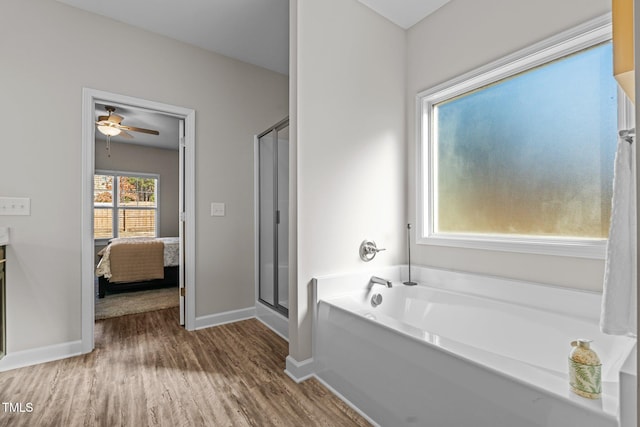 bathroom with wood-type flooring, ceiling fan, and independent shower and bath