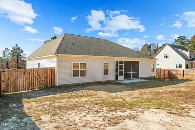 back of property featuring a lawn and a patio