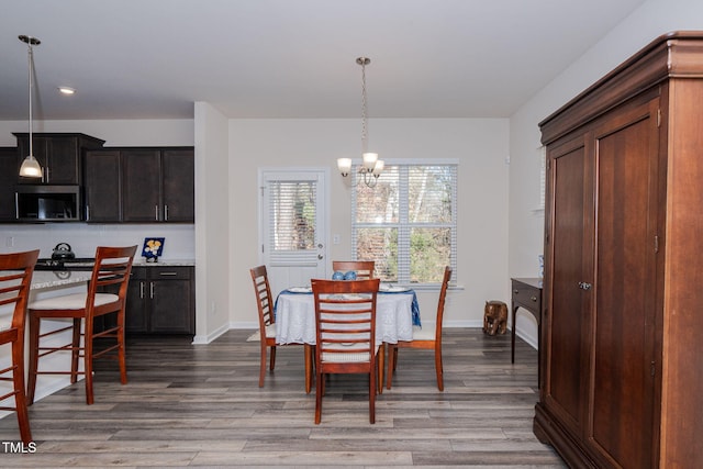 dining room featuring light hardwood / wood-style flooring and a notable chandelier