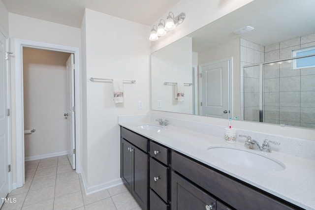 bathroom featuring vanity, tile patterned floors, and a shower with shower door