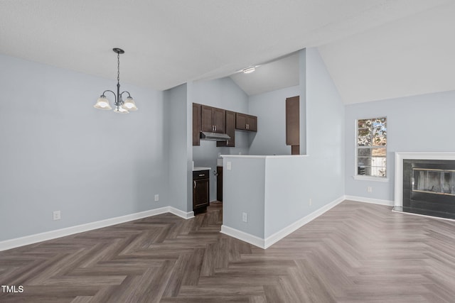 unfurnished living room with dark parquet floors, a chandelier, and vaulted ceiling