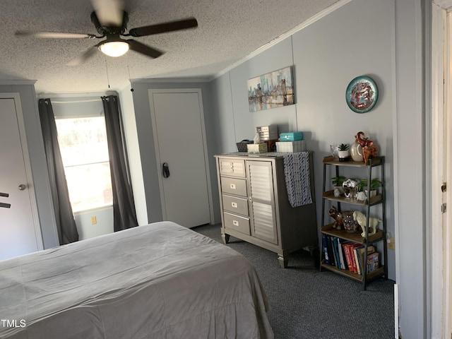 carpeted bedroom with ceiling fan, a textured ceiling, and ornamental molding