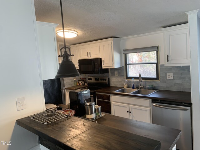 kitchen featuring decorative backsplash, appliances with stainless steel finishes, a textured ceiling, sink, and white cabinets