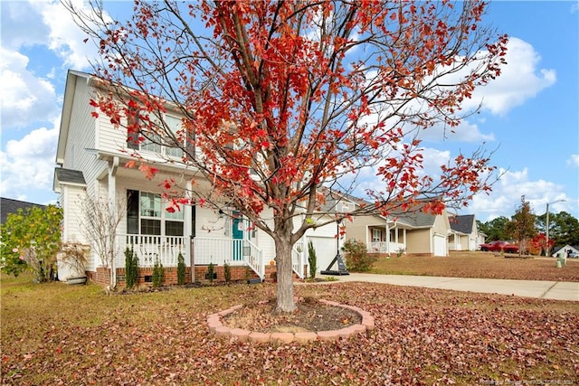 view of front of property with a porch and a front lawn