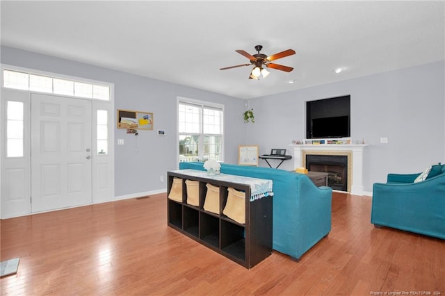 living room featuring hardwood / wood-style floors and ceiling fan