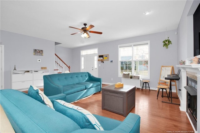 living room featuring ceiling fan and light wood-type flooring