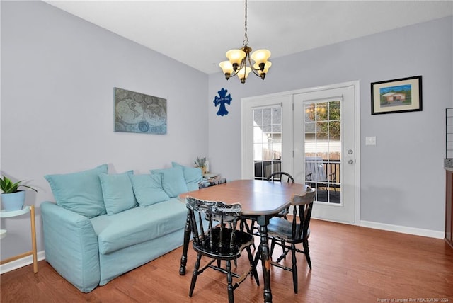 dining room with a chandelier and hardwood / wood-style floors