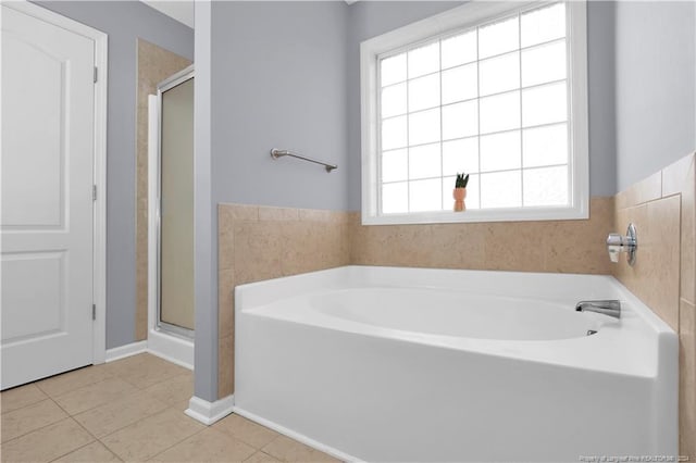 bathroom featuring tile patterned flooring and plus walk in shower