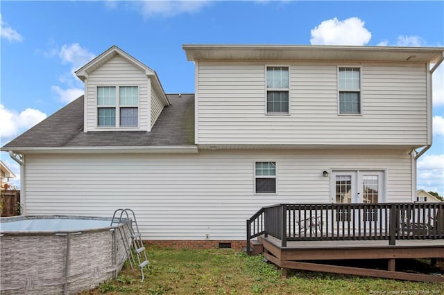 back of property featuring a yard and a wooden deck