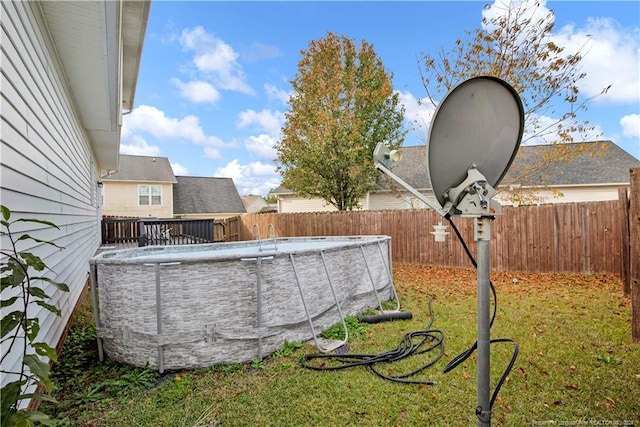 view of yard with a fenced in pool