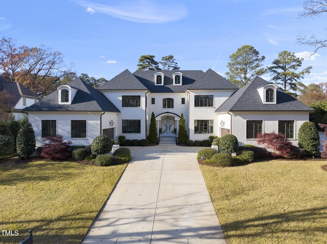 french country style house featuring a front lawn