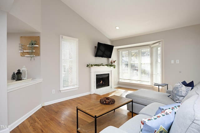 living room featuring hardwood / wood-style floors and vaulted ceiling