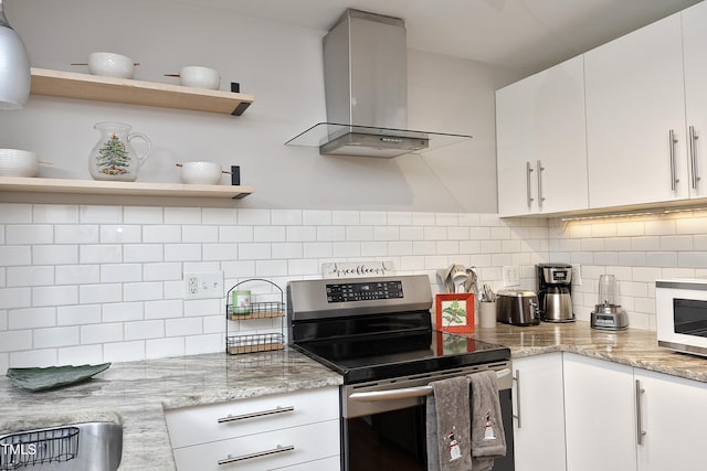 kitchen with white cabinetry, electric range, and wall chimney range hood