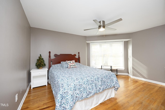 bedroom with hardwood / wood-style floors and ceiling fan