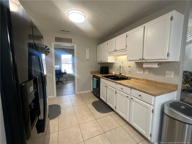 kitchen featuring sink, white cabinets, stainless steel refrigerator with ice dispenser, and light tile patterned floors