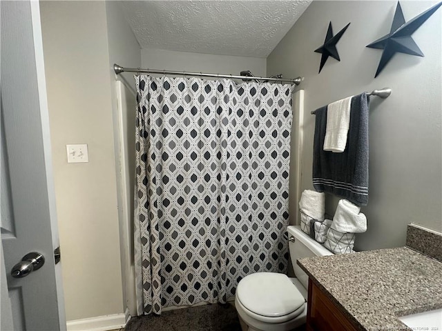 bathroom with a shower with curtain, vanity, a textured ceiling, and toilet