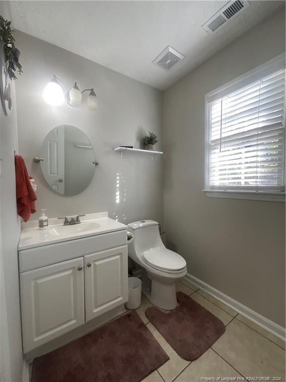 bathroom featuring tile patterned flooring, vanity, and toilet