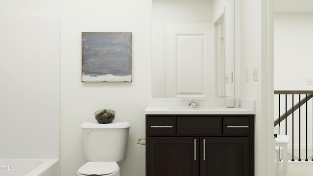 bathroom featuring a bathing tub, vanity, and toilet