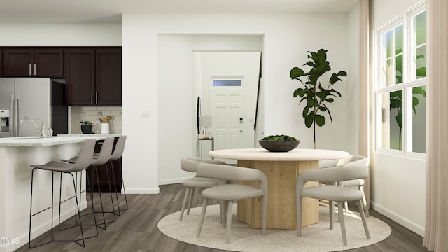 dining room with dark hardwood / wood-style flooring and sink