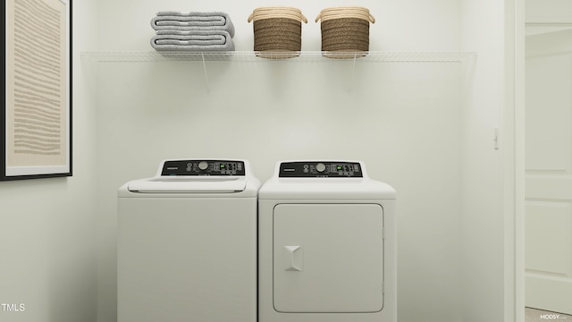 clothes washing area featuring washer and dryer