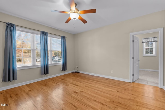 spare room featuring ceiling fan and light wood-type flooring