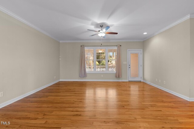 empty room featuring light hardwood / wood-style floors, ceiling fan, and crown molding