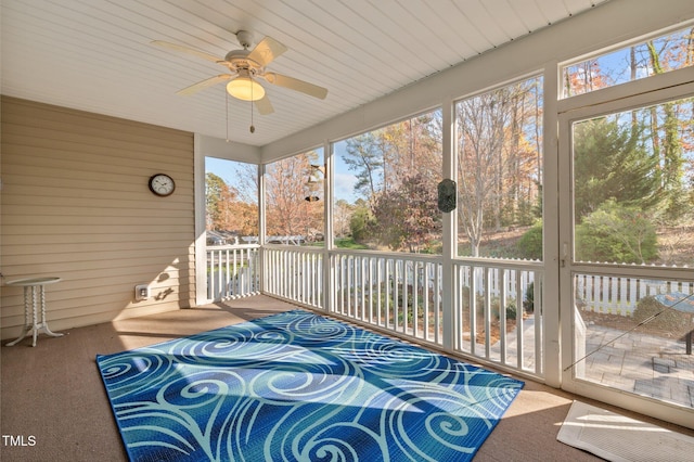 sunroom featuring ceiling fan