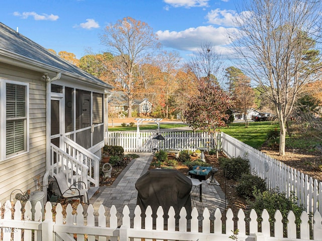 wooden deck with a sunroom, a patio area, and grilling area